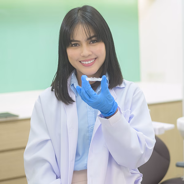 Young female dentist holding invisalign in dental clinic, teeth check-up and Healthy teeth concept